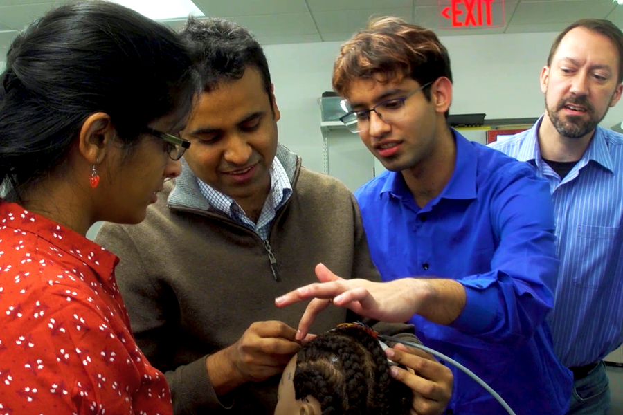 ECE professors with students in the lab