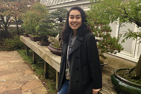 Headshot of student outside by plants