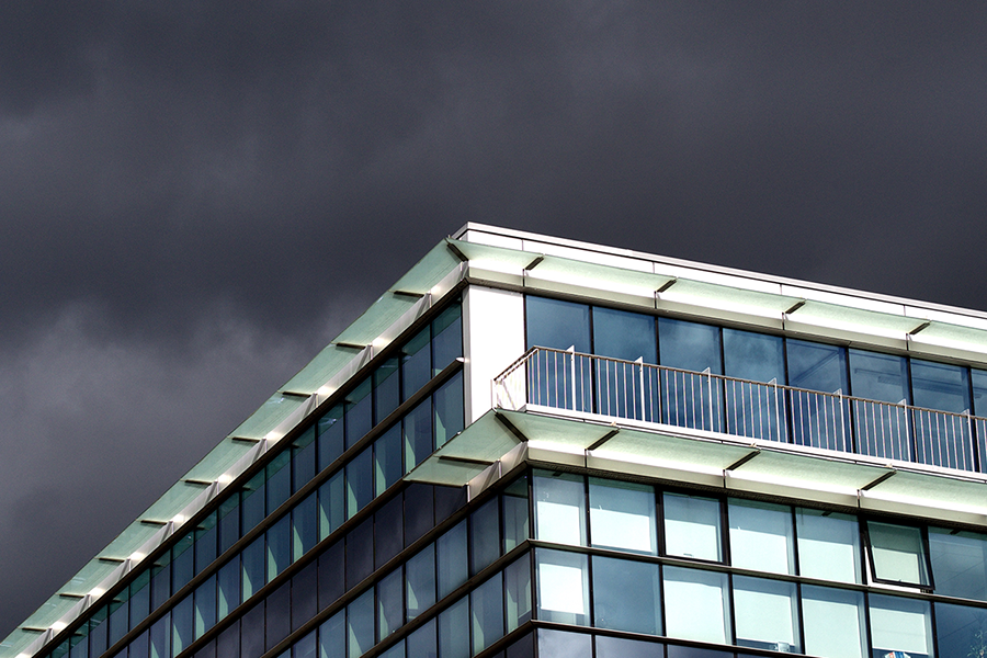 Edge of building with a stormy sky