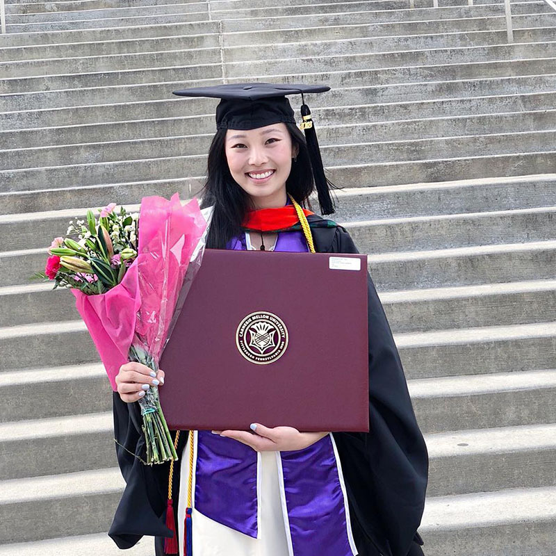 Lisa Yan on the steps of Hamerschlag Hall after graduation