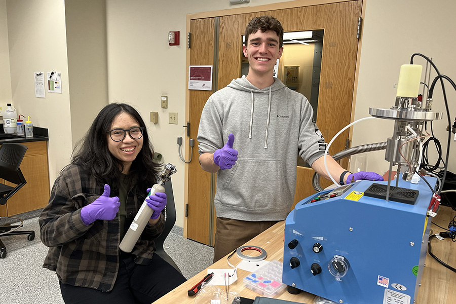students giving thumbs up in the lab