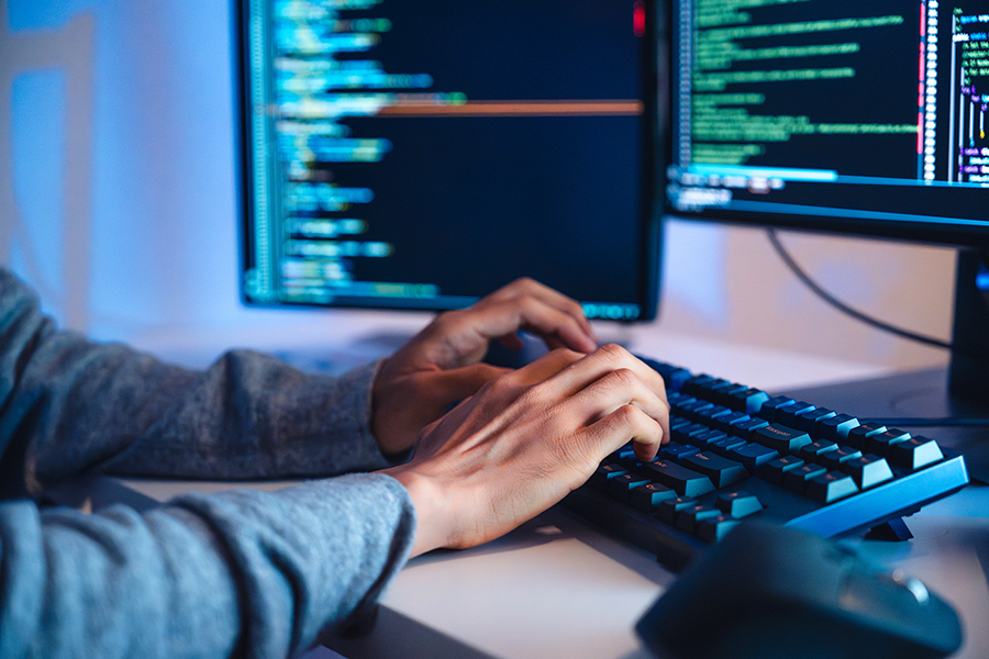 Person typing computer code 