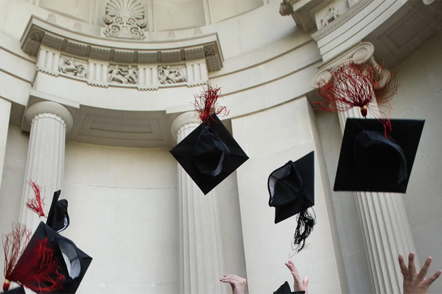 Students throwing graduation caps.